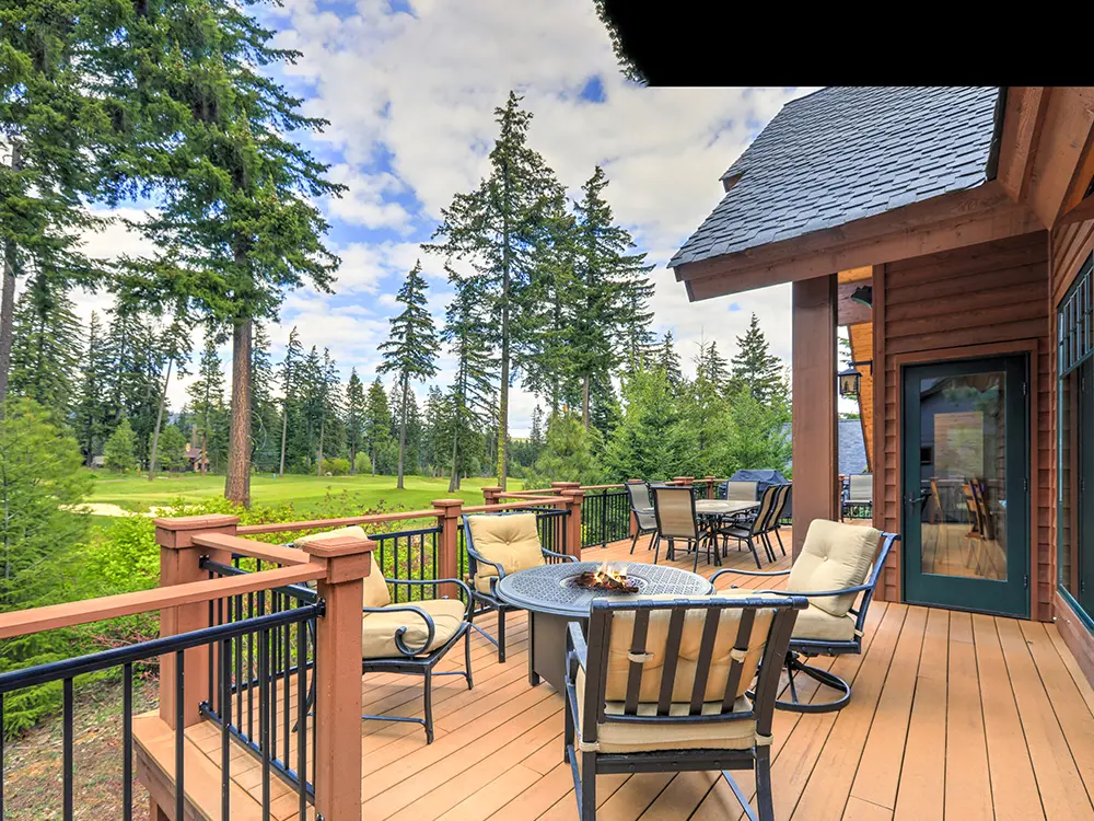 A deck with outdoor furniture and a fireplace