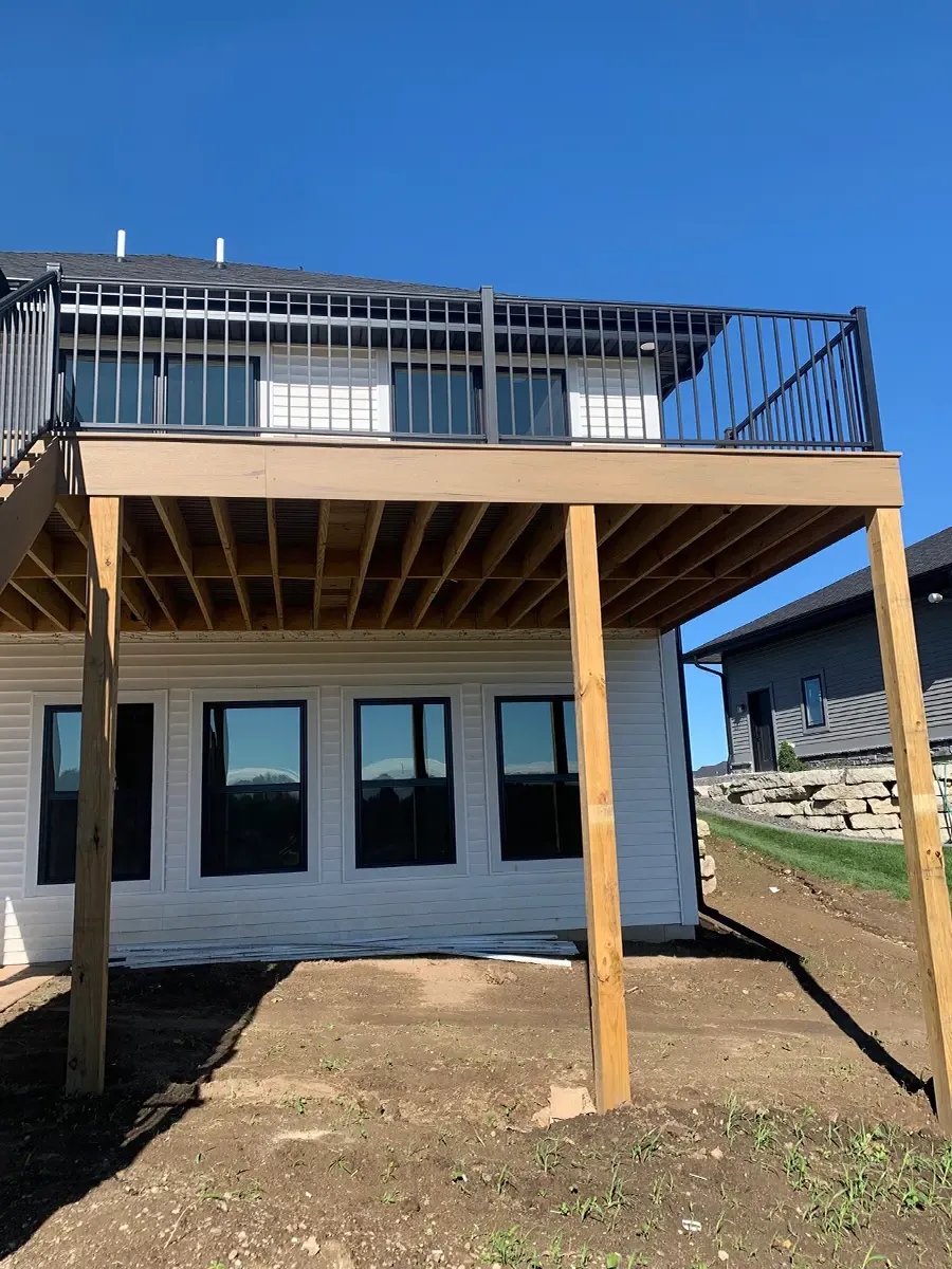 Pressure treated deck frame with metal railing