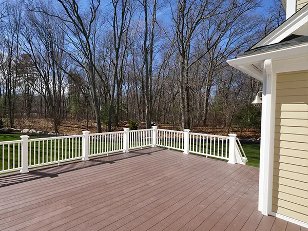 Brown PVC decking with white metal railing