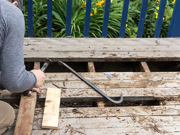 Tearing down damaged decking boards