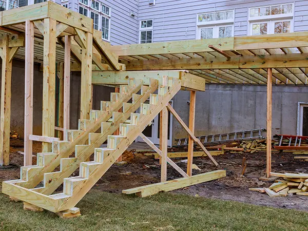 Pressure-treated deck framing for an elevated structure