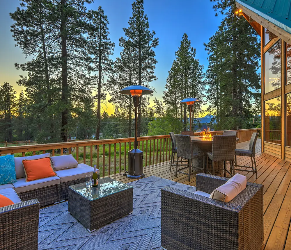 Wood decking with outdoor furniture and a fireplace