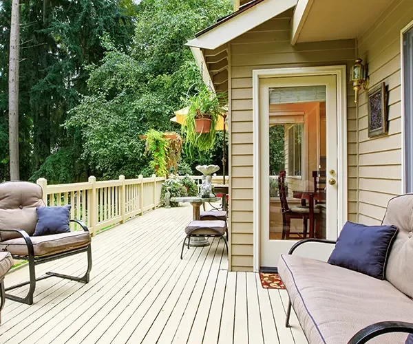 Deck repair in Waunakee, WI with beige wood decking and home siding